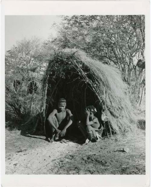 "Living places, shelters": Tsamgao and Bau sitting in front of their skerm (print is a cropped image)