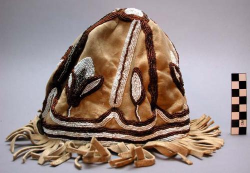 Woman's cap, caribou skin. Bottom fringe. Beaded flower designs all over.