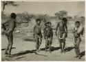 "Children in groups": Boys and girls dancing, with a girl playing the //guashi; "Little N!ai" is standing fourth from the left (print is a cropped image)