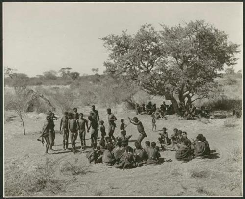 "1952, The Daytime Dance at Gautscha, various scenes of the circle": Men dancing in front of a group of women sitting (print is a cropped image)