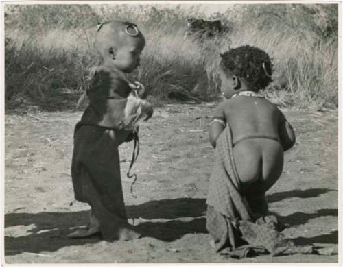 [No folder title]: Children playing in a cleared space (print is a cropped image)