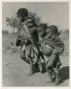 "Carrying children": Be and ≠Gisa carrying babies tied in their karosses (print is a cropped image)