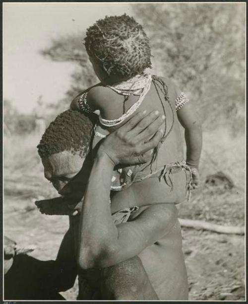 "Fathers carrying children": "Gao Medicine" carrying his son, /Gaishay, on his shoulder (print is a cropped image)