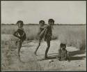 [No folder title]: Girls playing the "piggy-back" game at the pan, including ≠Gisa (daughter of ≠Gao and Khwo//o-/Gasa), "Little !Nai" and ≠Nisa (print is a cropped image)