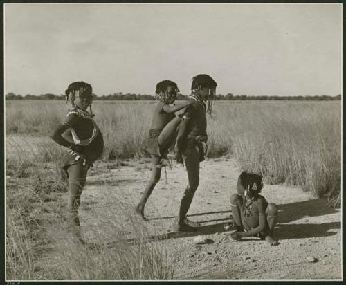 [No folder title]: Girls playing the "piggy-back" game at the pan, including ≠Gisa (daughter of ≠Gao and Khwo//o-/Gasa), "Little !Nai" and ≠Nisa (print is a cropped image)