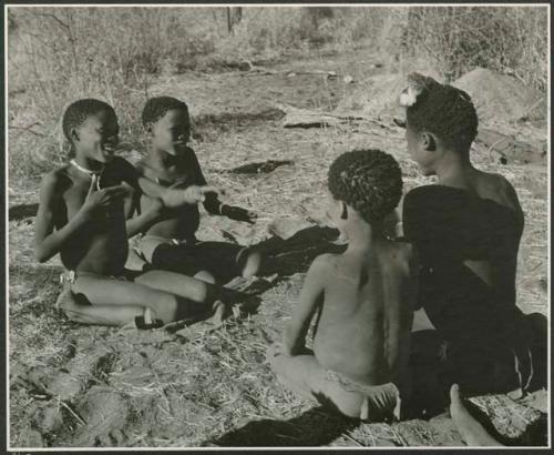 "Porcupine or Axe and Assegai [game]": Boys playing !ó'm!hú / !’Om g!xuni / ’Ai kota !U!u g!xuni / N!aih //’an (the porcupine game, also known as the axe game, assegai game or war game), including Gao (son of ≠Gao and Khwo//o-/Gasa of Band 4) and /Gishay (son of "Old Gau," Band 1) (print is a cropped image)