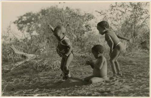 "Children playing curing dance": /Gaishay (son of Di!ai and "Gao Medicine"), Bau (daughter of "Crooked /Qui" and //Khuga), and "Little ≠Gao" (son of "/Qui Navel" and //Kushay) dancing a medicine dance (print is a cropped image)