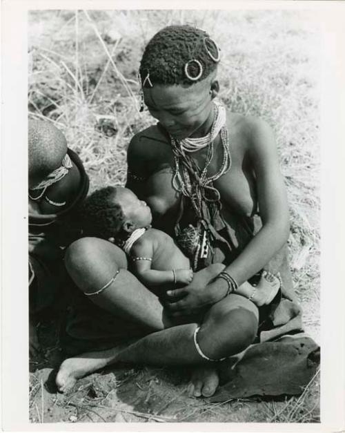 "Babies nursing": Mother nursing a baby (print is a cropped image)