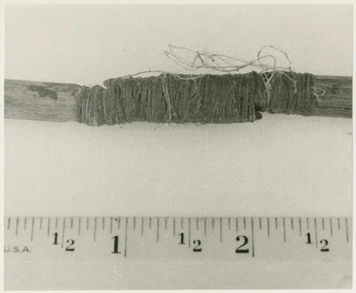 Oukwane's !ga!gaba ("male" stick of a pair of firesticks), broken and spliced together, with a ruler for measurement (print is a cropped image)