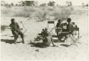 Scene of an interview; left to right: Dabe, Oukwane, Lorna Marshall, Kernel Ledimo, and another unidentified man behind (print is a cropped image)