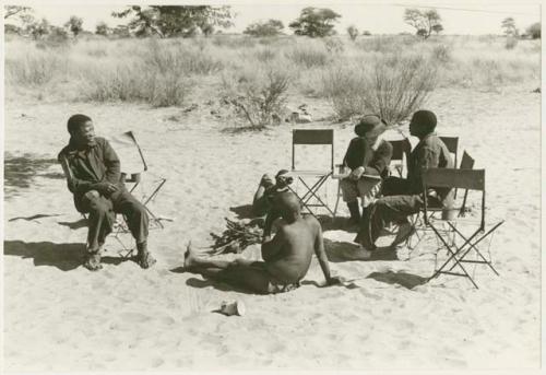 Scene of an interview; left to right: Dabe, Oukwane, Lorna Marshall, Kernel Ledimo, and another unidentified man behind (print is a cropped image)