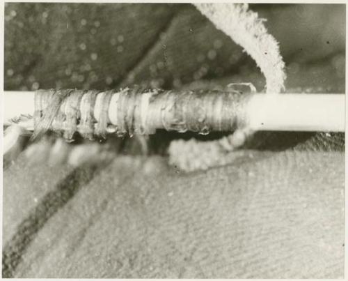 Close-up of winding, presumably at the end of a bow (print is a cropped image)