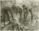 !Gai and two visiting men washing by a fire (print is a cropped image)