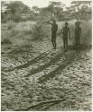 Three boys dancing, seen from a distance (print is a cropped image)