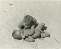 Two boys playing, rolling in the sand (print is a cropped image)