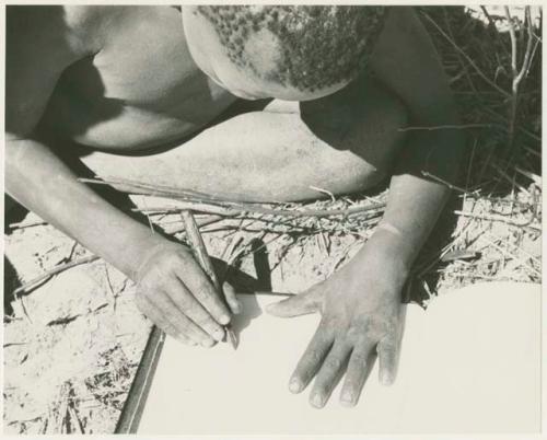 Boy holding a pen (print is a cropped image)