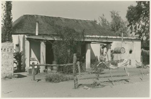 House with thatched roof (print is a cropped image)