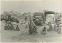 Group of Ju/'hoansi in front of the tents and trucks at the expedition camp (print is a cropped image)