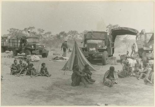 Group of Ju/'hoansi in front of the tents and trucks at the expedition camp (print is a cropped image)