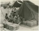 Women waiting outside a tent in which expedition members are dressing /Naoka (/Qui's second wife) and her daughter, /Khoa (print is a cropped image)