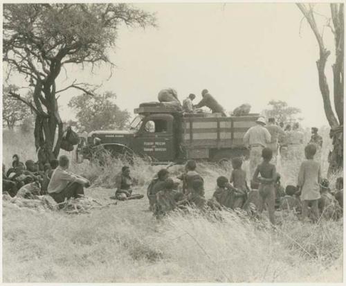 The expedition and a group of Ju/'hoansi gathered around the truck (print is a cropped image)