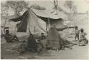 Group of Ju/'hoansi lying in front of one of the expedition tents (print is a cropped image)