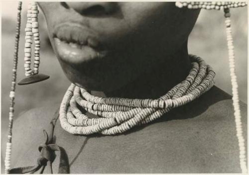 Close-up of ostrich eggshell beads worn by a visiting girl (print is a cropped image)