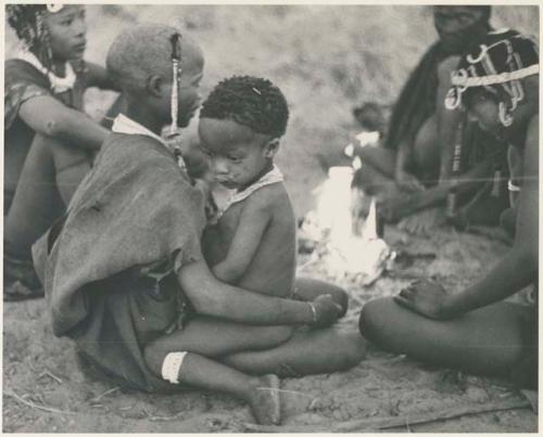 !Ungka Norna sitting on the lap of a visiting girl (print is a cropped image)