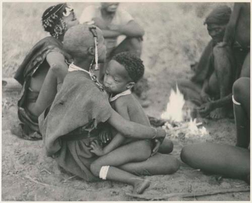 !Ungka Norna sitting on the lap of a visiting girl (print is a cropped image)