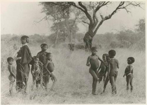 Girls and other children standing in groups (print is a cropped image)