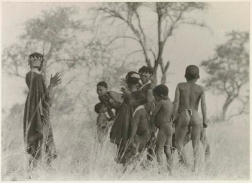 Boys dancing and girls clapping (print is a cropped image)