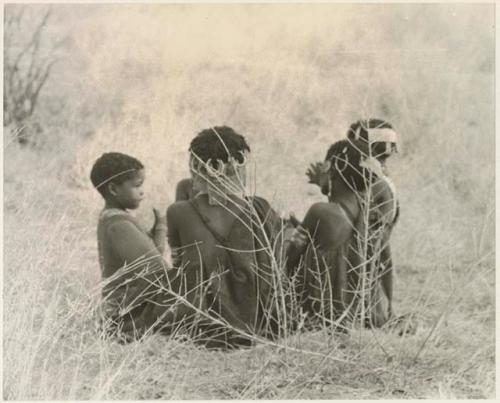 Group of children sitting in grass (print is a cropped image)