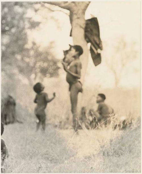 Boys dancing, seen from a distance (out of focus; print is a cropped image)