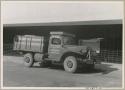 Truck in town, with sign painted on side reading "Peabody Museum of Harvard University" (print is a cropped image)