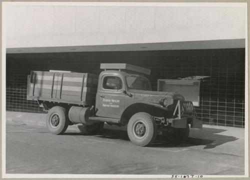 Truck in town, with sign painted on side reading "Peabody Museum of Harvard University" (print is a cropped image)