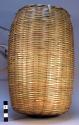 Large basket (11" high) made of wild bamboo by the men; storage for seeds