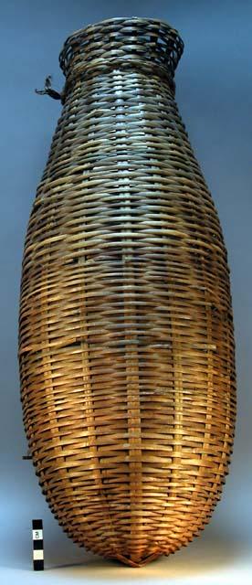 Large basket made of wild bamboo by men (about 2 ft. high); used for storage of