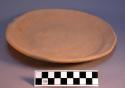 Small cooking griddle, pottery.  Unslipped but burnished on top surface.  Shape