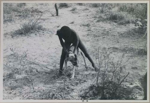 Boy holding a dog
