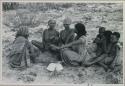 Group of women sitting and playing the dandiri