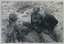 Group of women sitting and playing a dandiri
