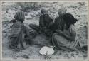 Group of women sitting and playing a dandiri
