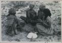 Group of women sitting and playing a dandiri

