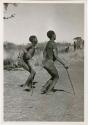 "Daytime Dance at Gautscha 1952, Early in the Dance, approach": Child dancing beside her father (print is a cropped image)