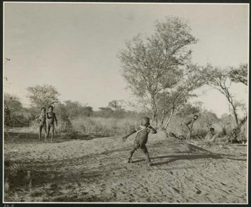 "Stick Throwing Game": Boys playing Bah n≠aq’u (the stick throwing game) (print is a cropped image)