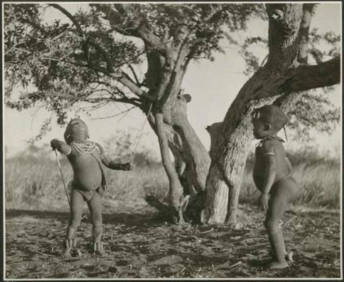 "Stick Throwing Game": /Gaishay and /Qui, trying to knock one of their sticks out of a tree (print is a cropped image), Bah n≠aq’u (the stick throwing game)