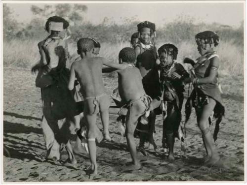 "N≠a N≠a Hau": Children playing N≠a N≠a Hau / N!hau-N!hau (the basket game) (print is a cropped image)