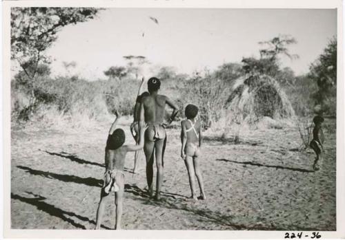 "The Jani [Djani]": Boys throwing a djani (helicopter toy) into the air (print is a cropped image)