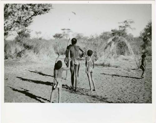 "The Jani [Djani]": Boys throwing a djani (helicopter toy) into the air (print is a cropped image)