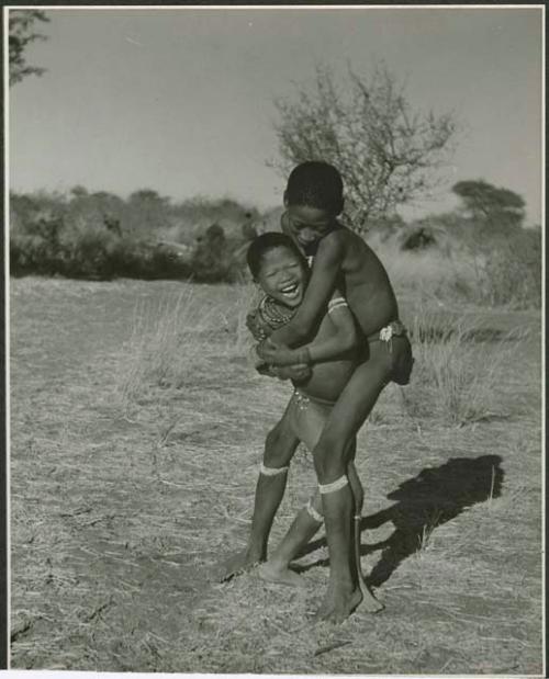 "Boys' play": Gao (son of ≠Gao and Khwo//o-/Gasa) standing with his arms around another boy (print is a cropped image)